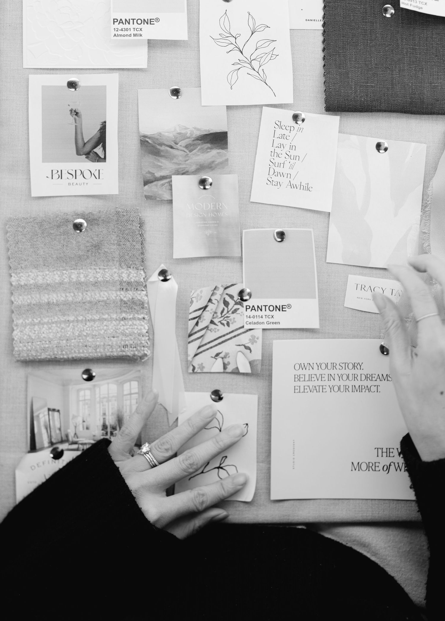 A moodboard or inspiration wall with various white papers and design elements pinned against a gray background.