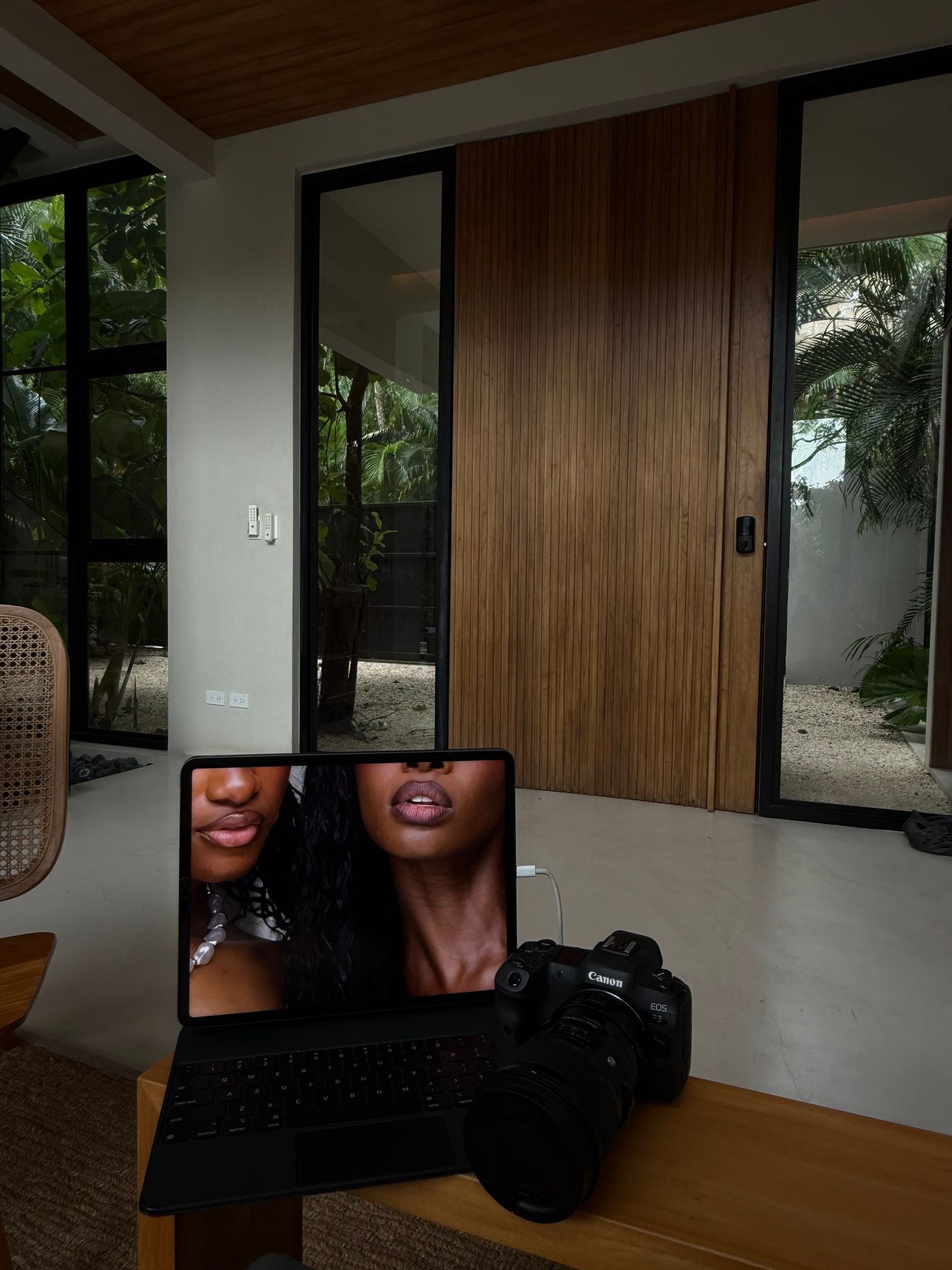 A modern interior room with wood paneling and large windows showing multiple cropped views of the space.
