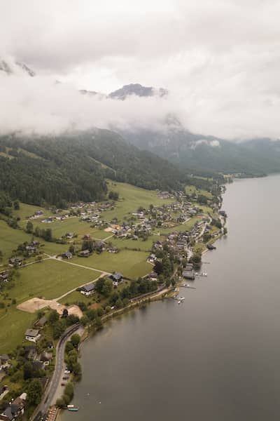 Drohnenaufnahme vom Ufer des Grundlsee. Wolken hängen tief.
