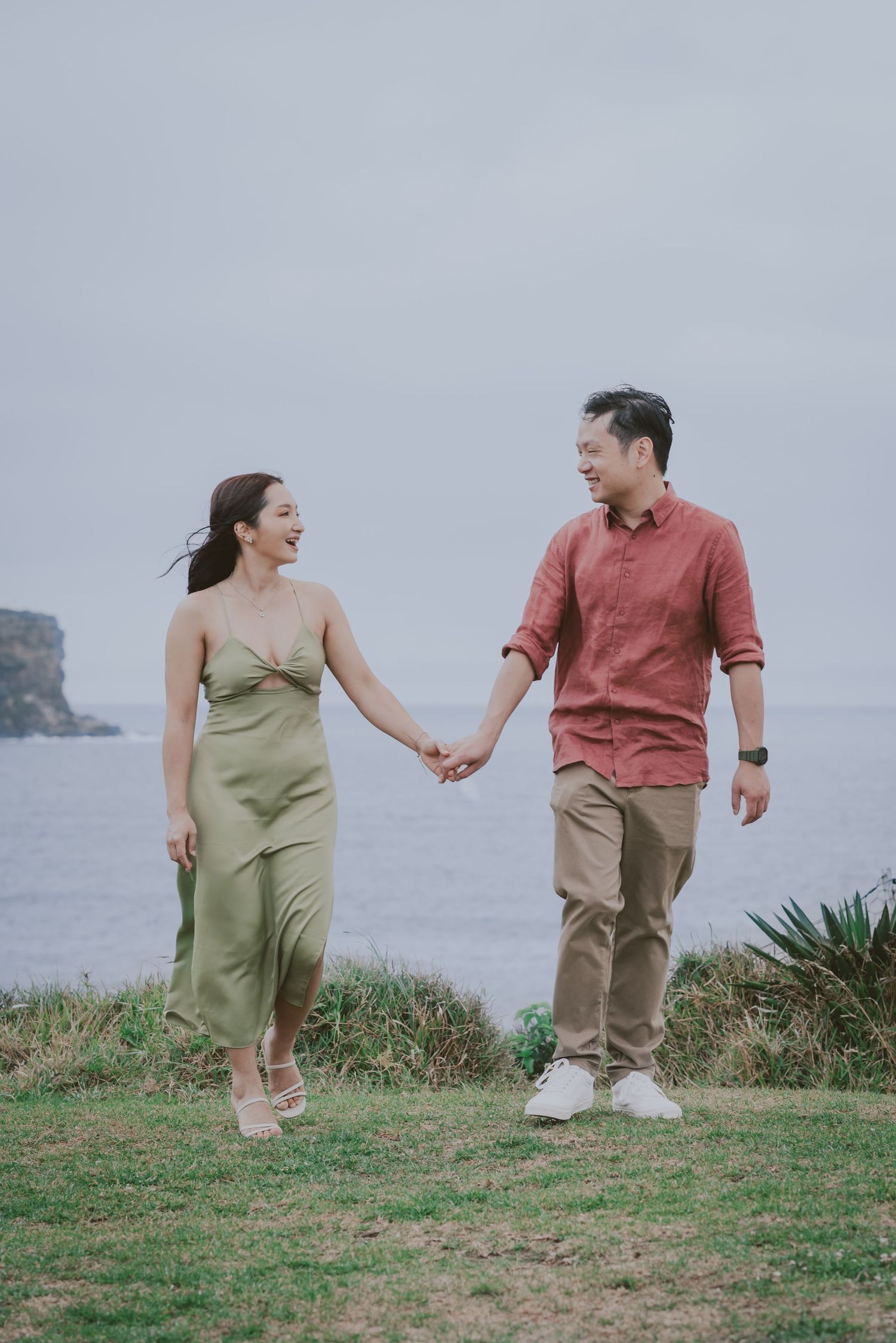 A couple enjoy each other company while posing for portraits.