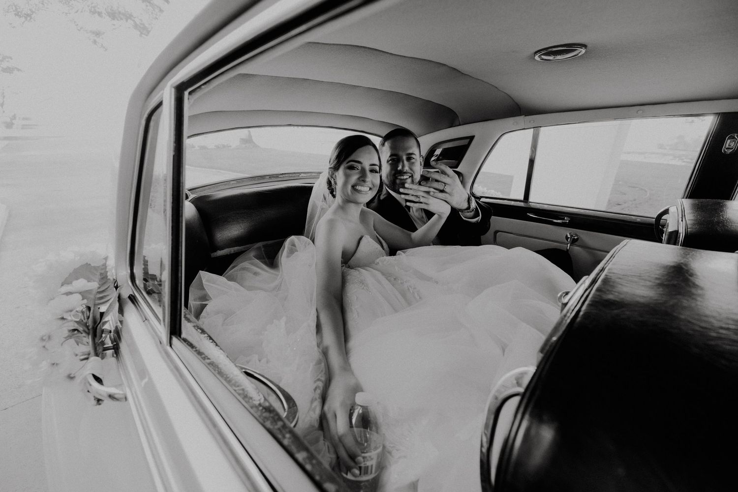 A black and white photo sequence shows someone driving a car and laughing while enjoying a scenic journey.