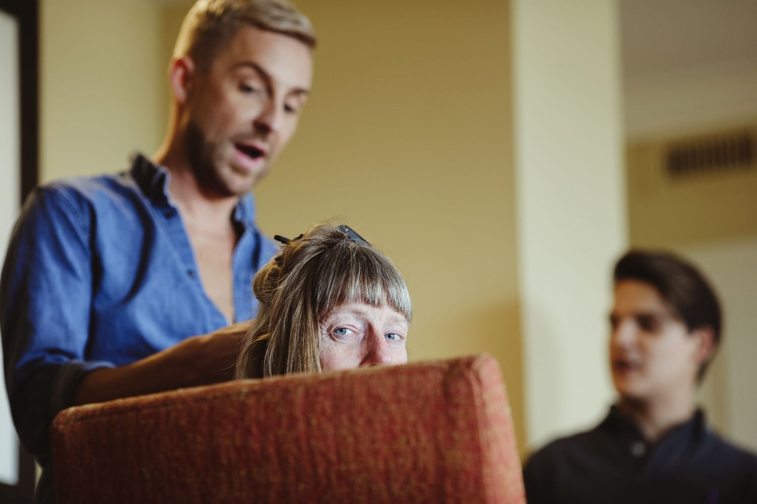 Emotional wedding guest crying during heartfelt ceremony speech indoors.