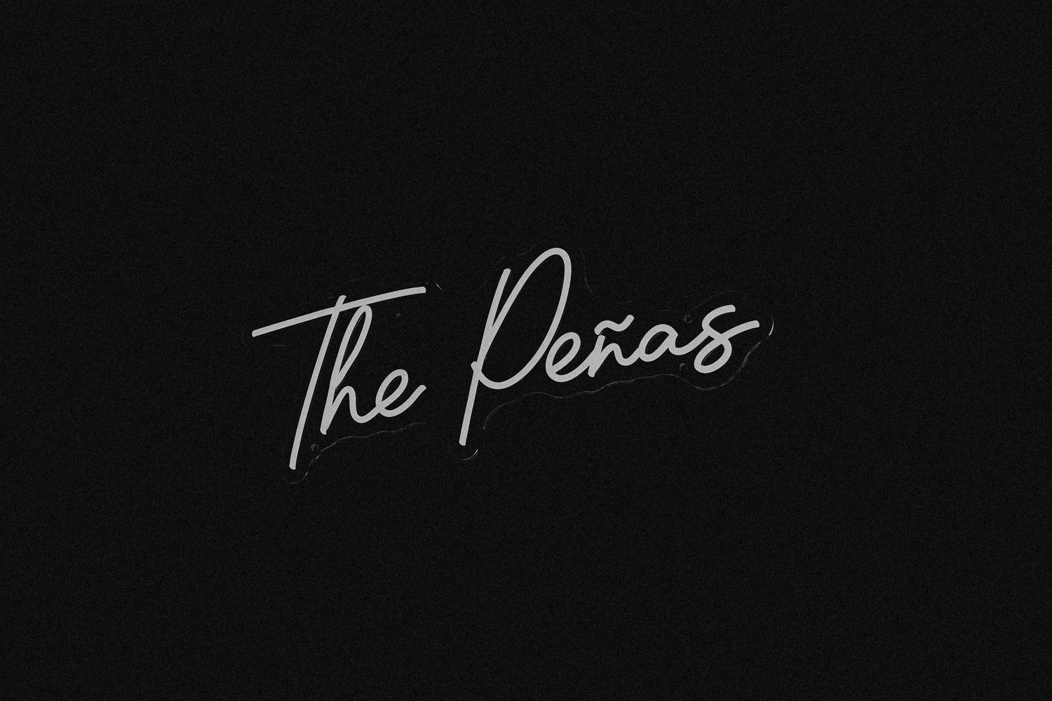 Elegant white cursive script reading The Peñas on a dark black background.