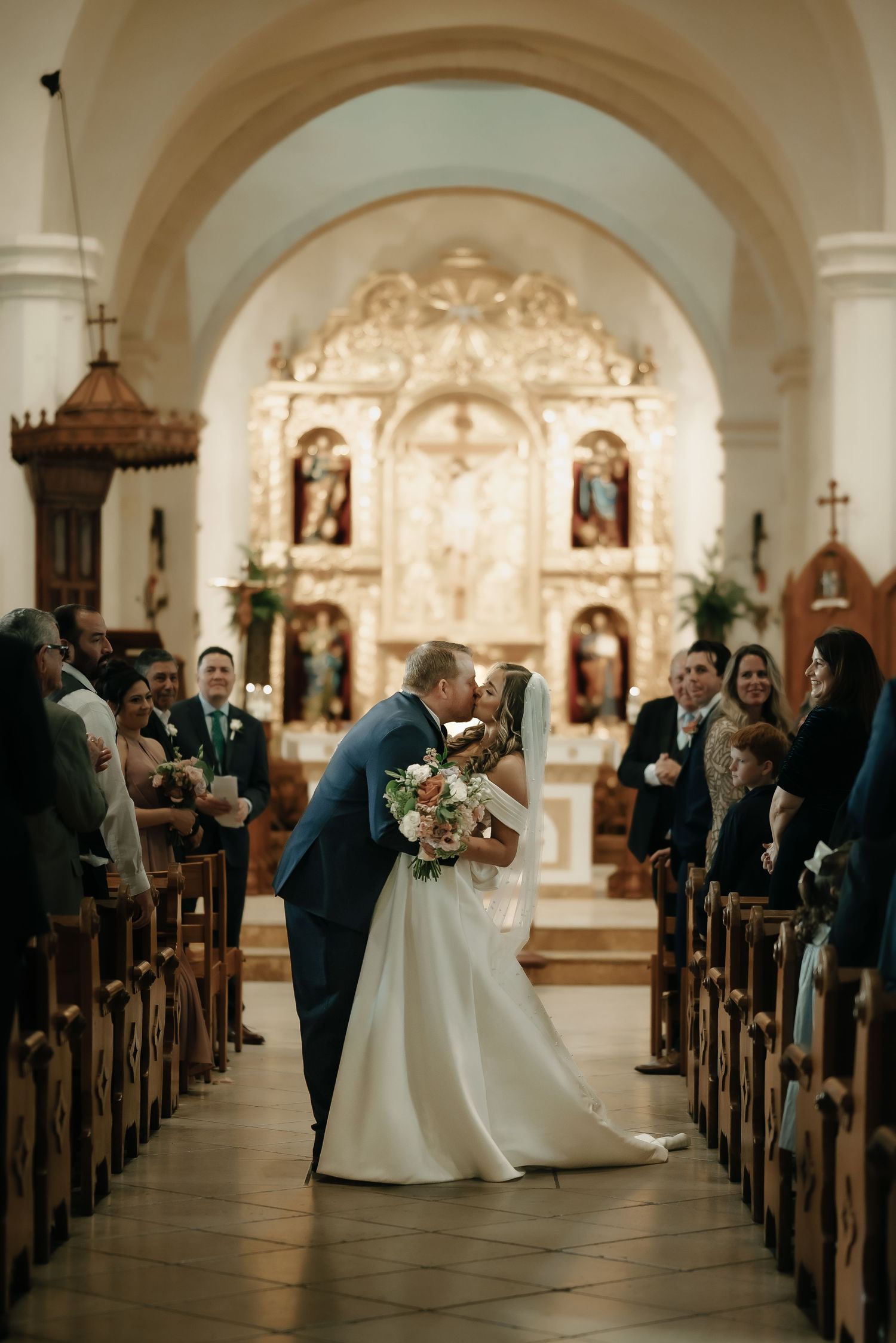 Traditional church wedding ceremony with arched ceilings and elegant white decor.