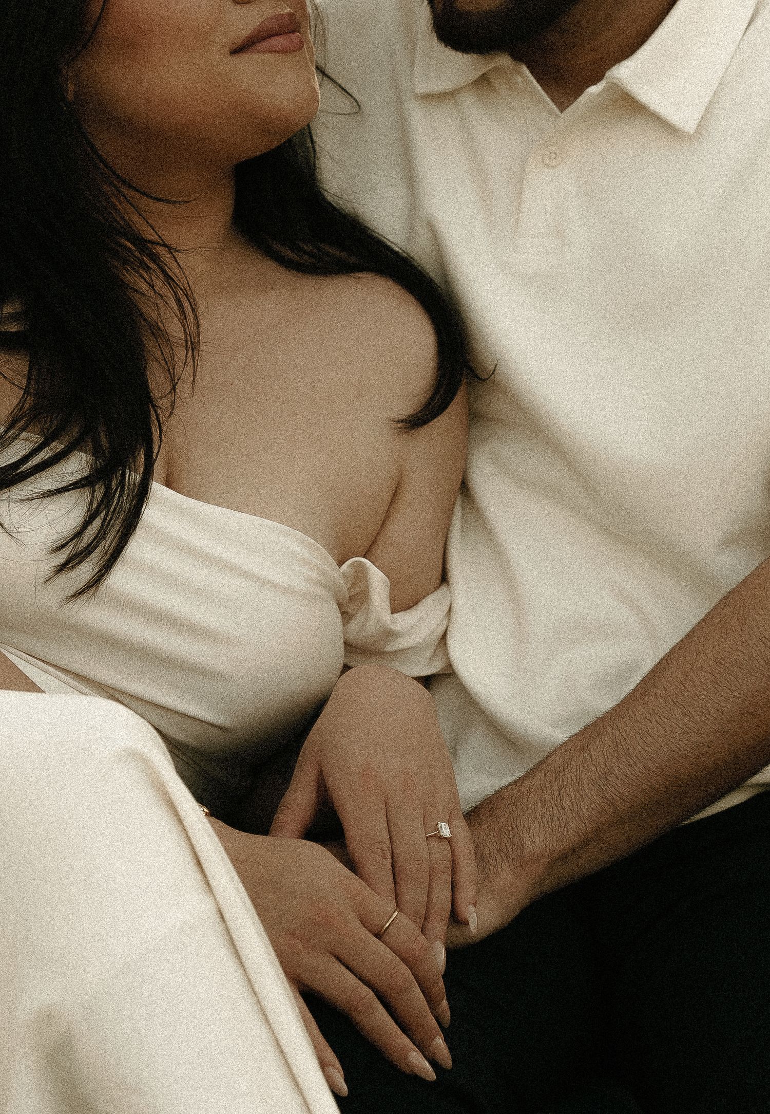 Intimate close-up portraits showing tender moments between a couple in white attire.