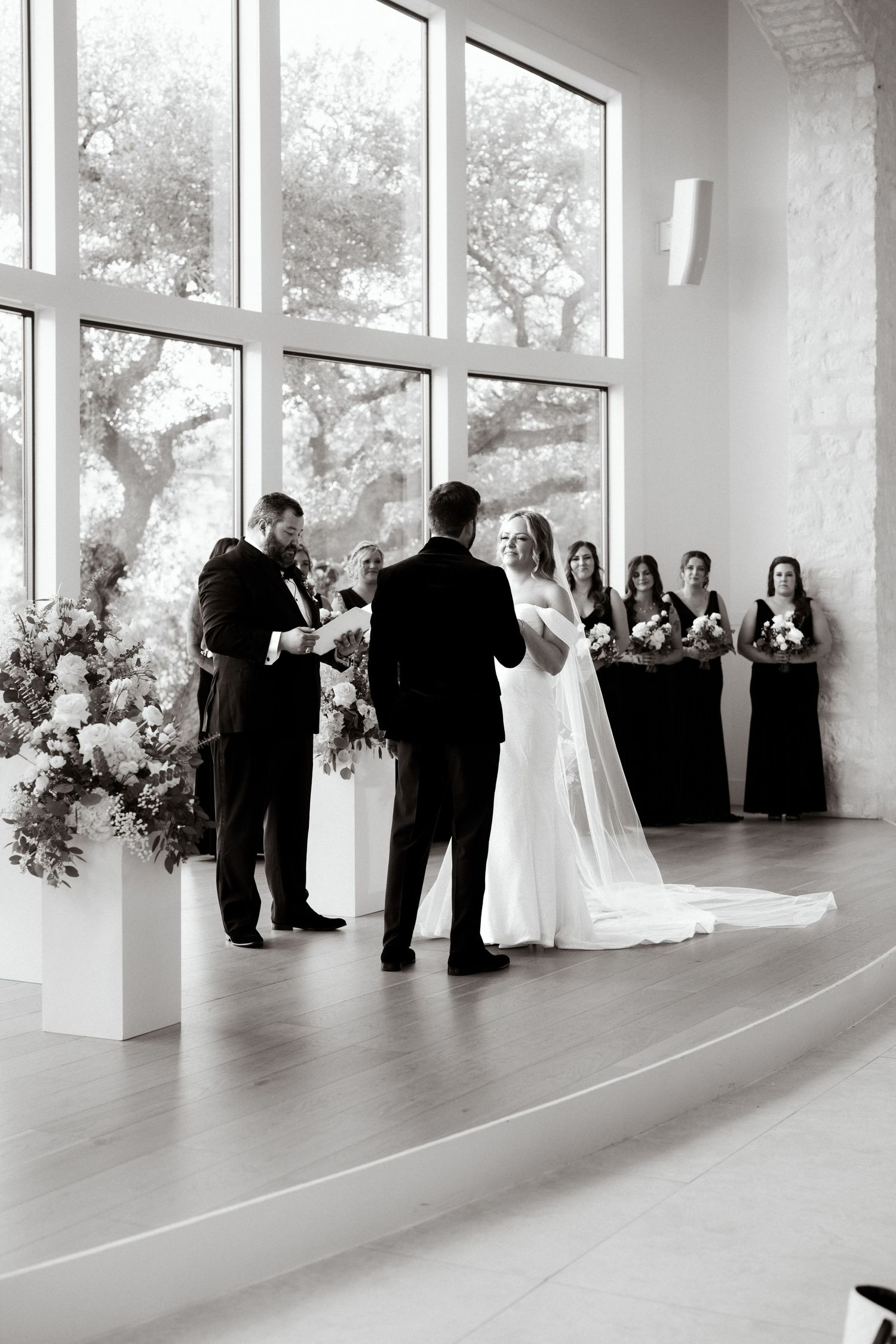 Wide angle shot of a wedding ceremony in progress in a bright contemporary space.