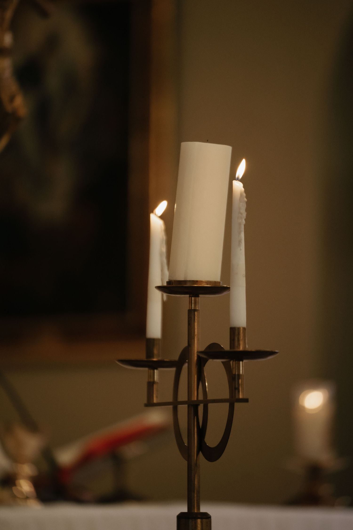 Candlelit atmosphere created by elegant metal candelabras in dim lighting.