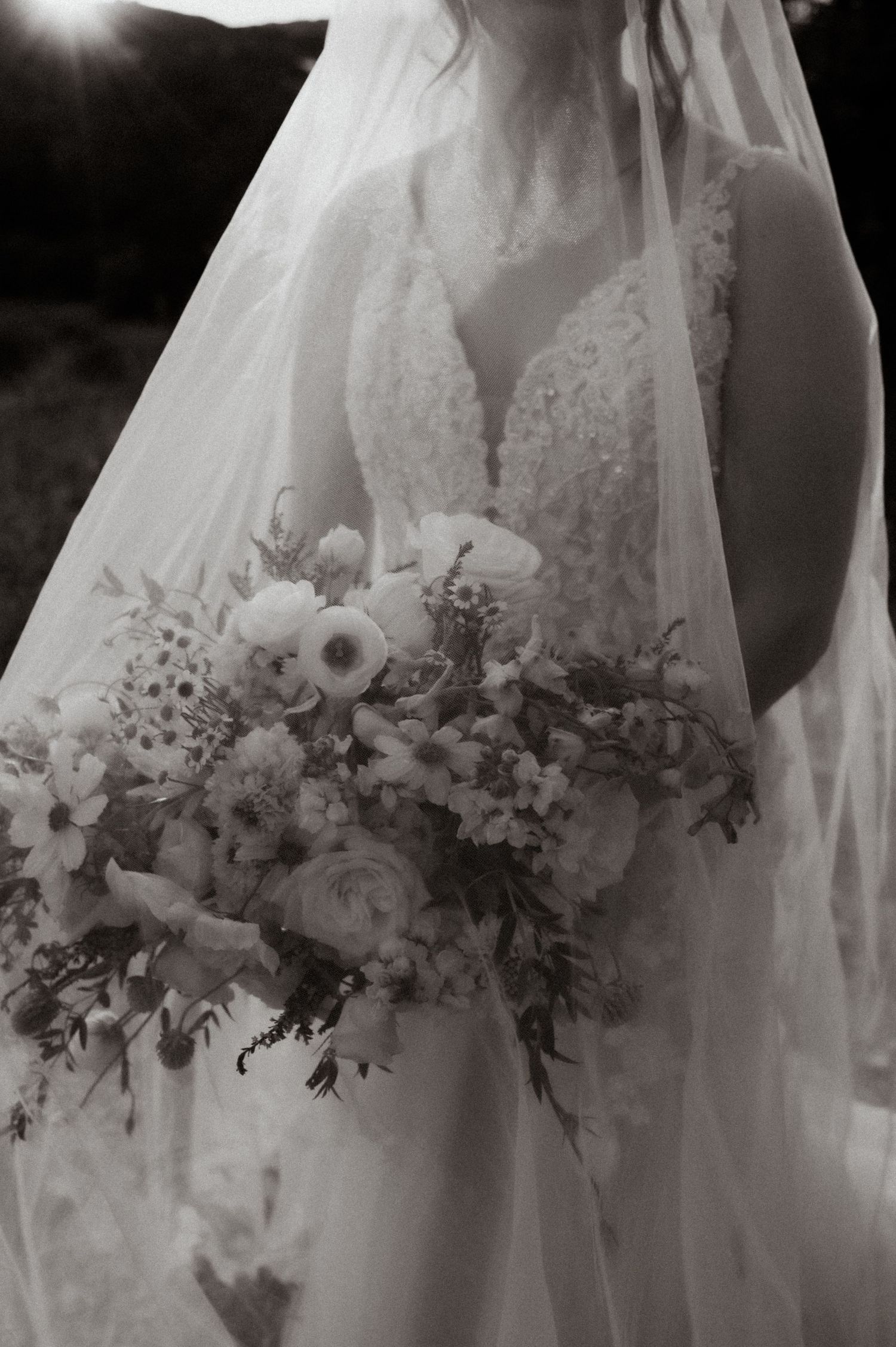 Elegant bridal bouquet with white flowers and greenery shown in a series of detailed black and white shots.