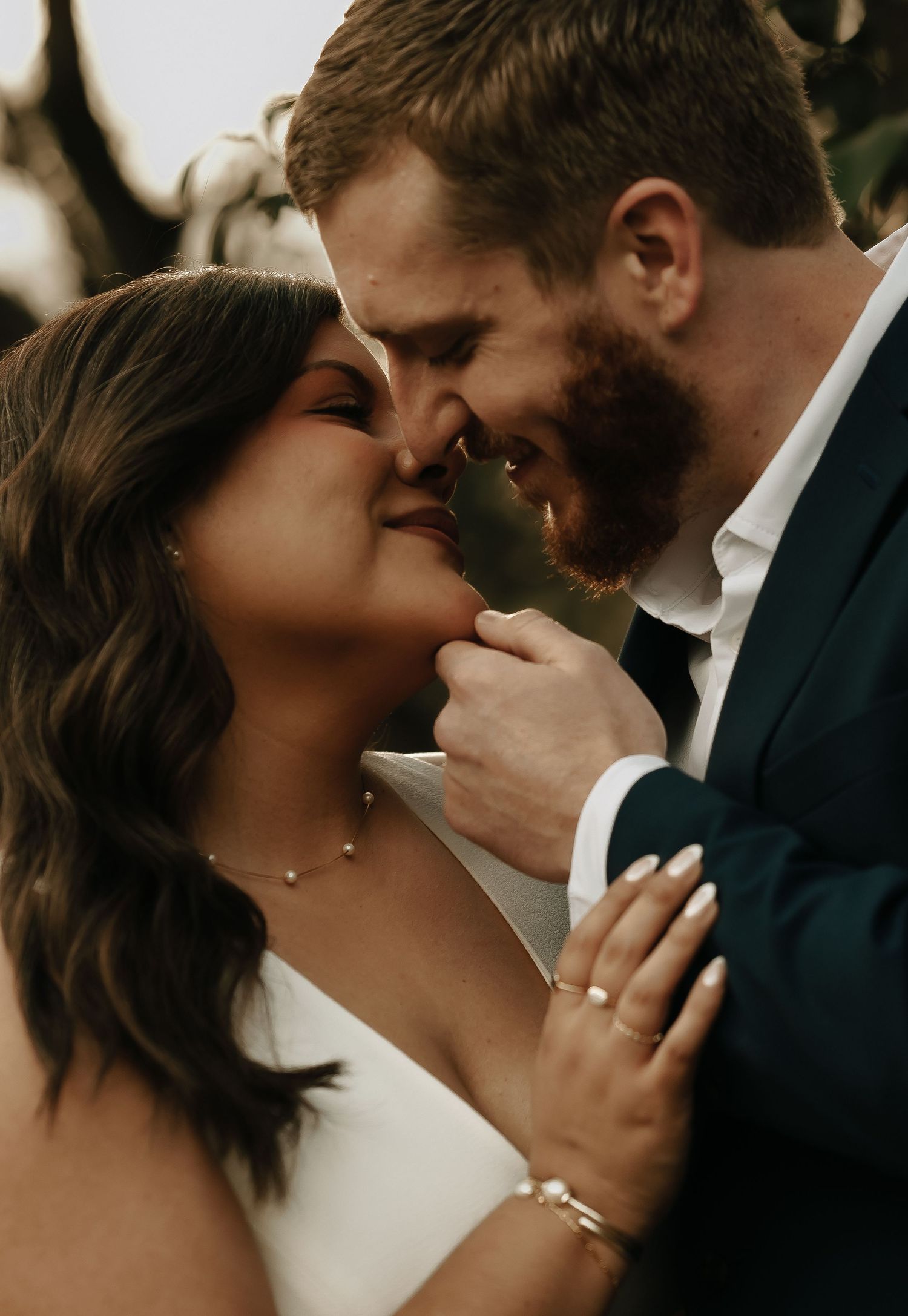 A close-up intimate moment between a couple in formal attire.