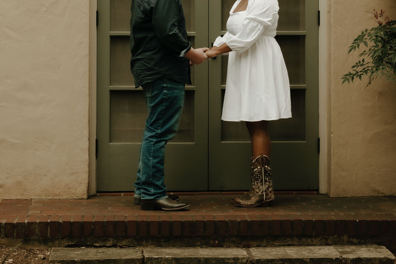Cropped view of two people's feet and legs standing on steps in contrasting outfits.