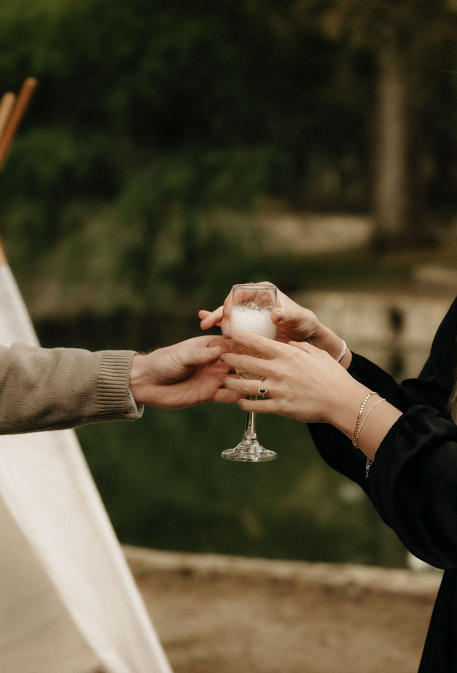 Close-up shots of hands exchanging rings during an intimate proposal moment.