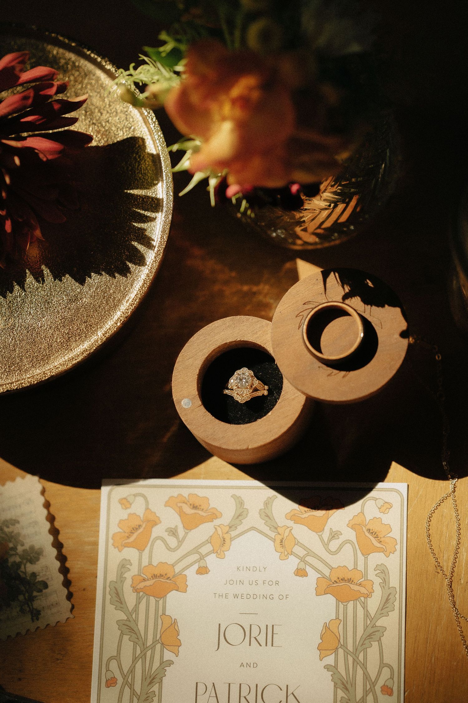 Wedding invitation with decorative details and floral motifs in warm lighting.
