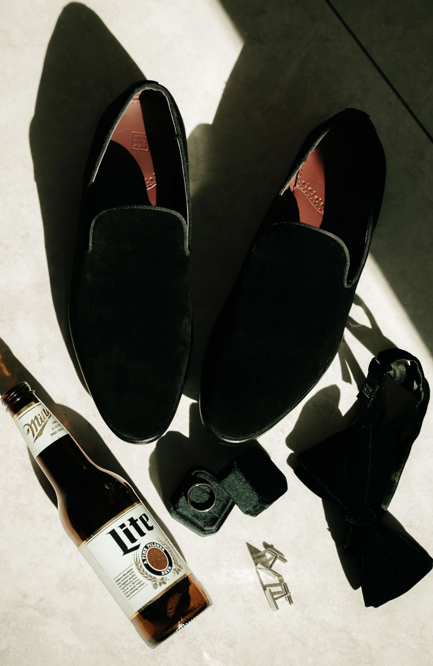 Dramatic lighting on black dress shoes lined up in a row.