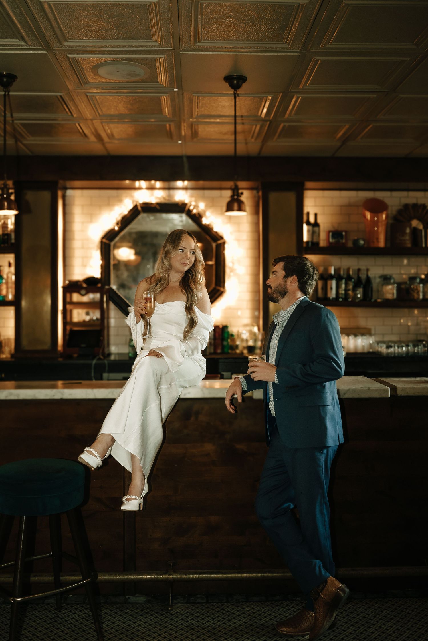 Couple dancing together in an elegant bar with ornate tin ceiling.