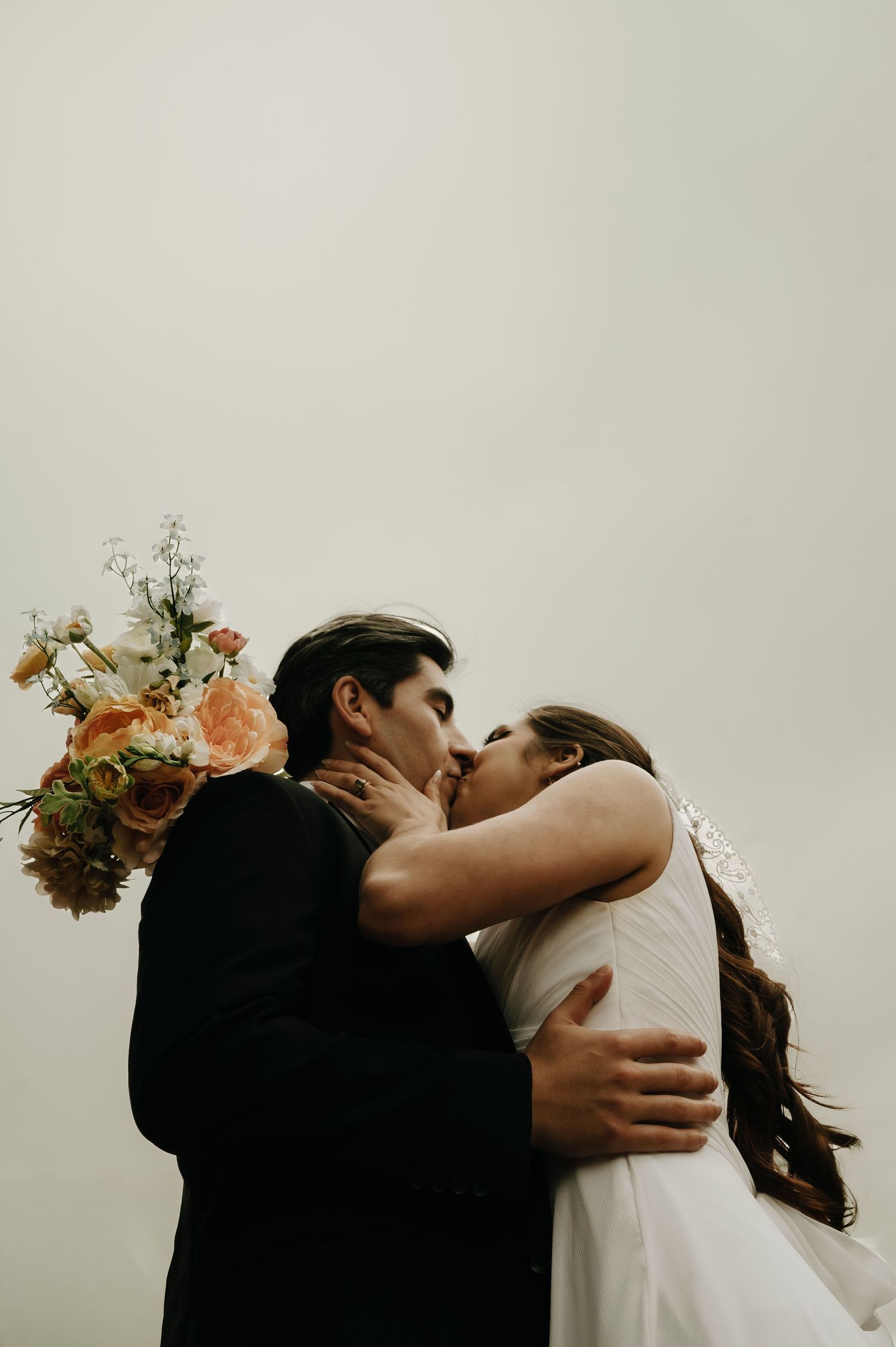 A sequence of romantic wedding photos showing a tender embrace against a light background.