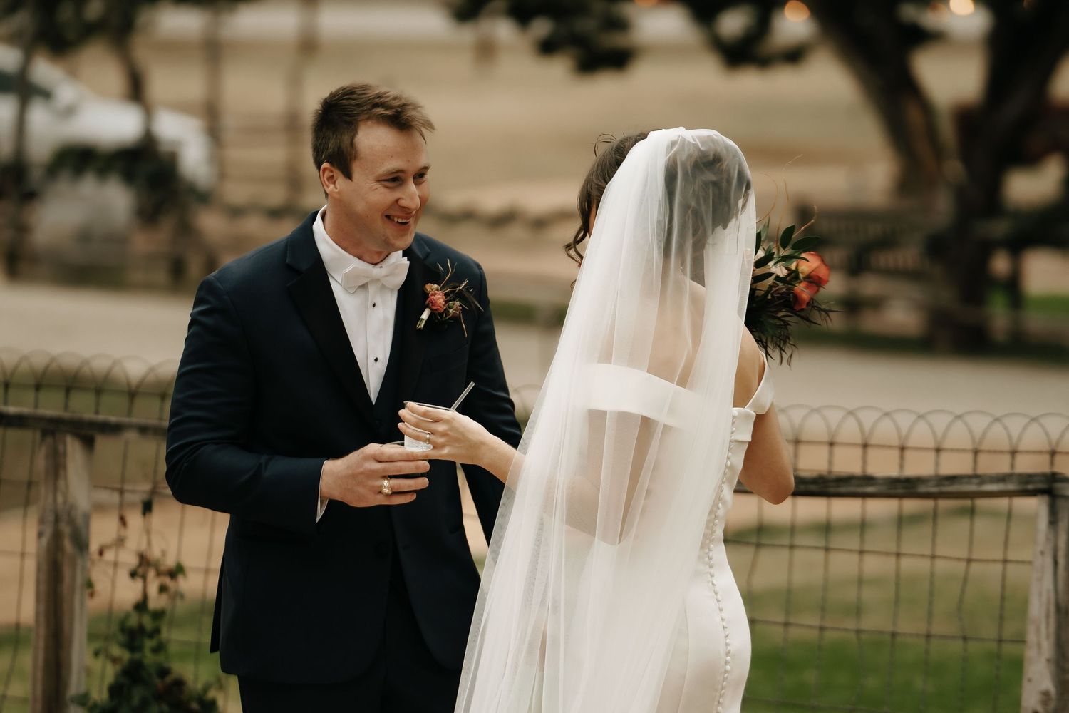 Outdoor wedding sequence showing couple in formal attire against natural backdrop.
