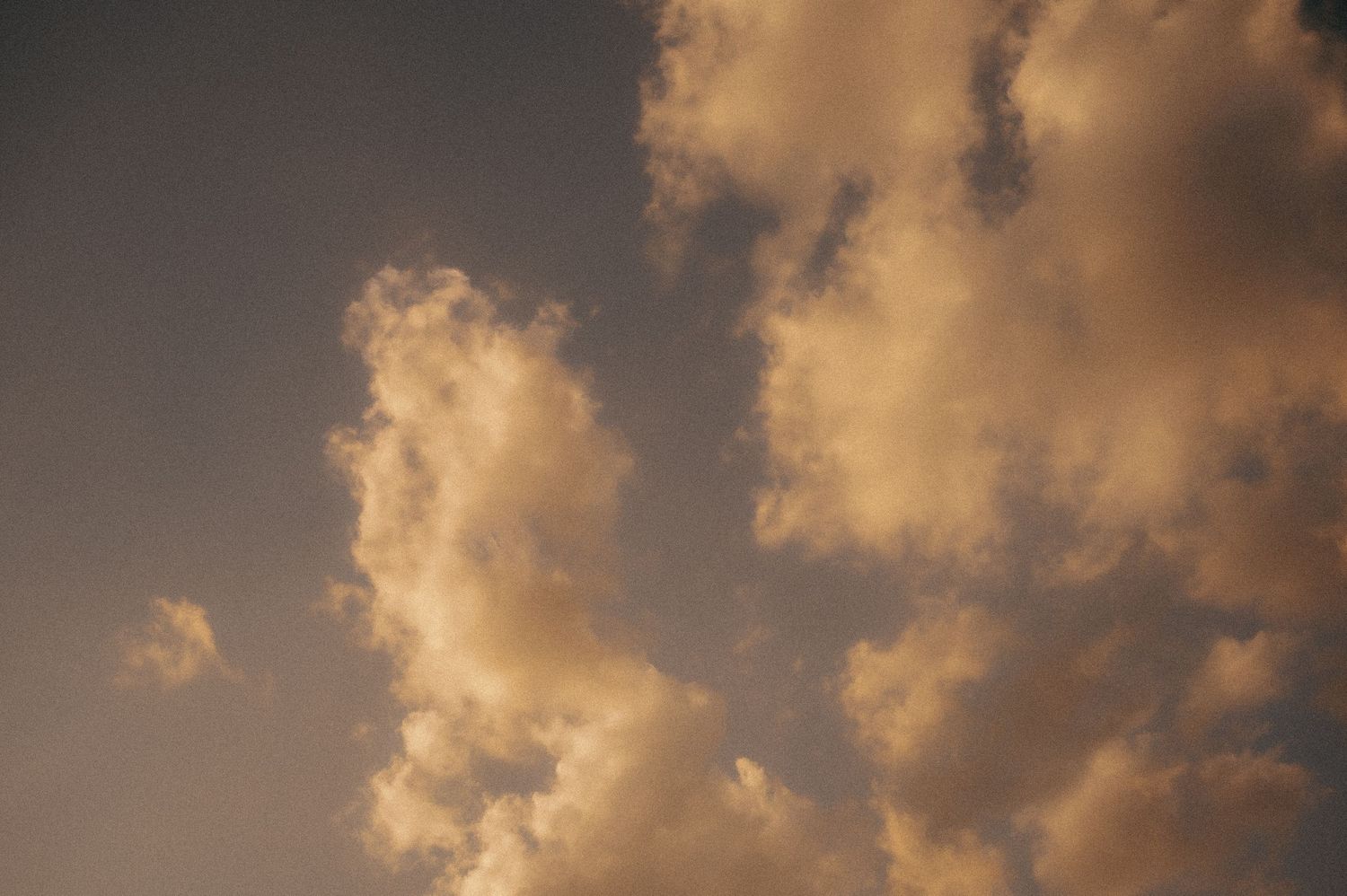 Warm orange sunset clouds filling the entire frame.
