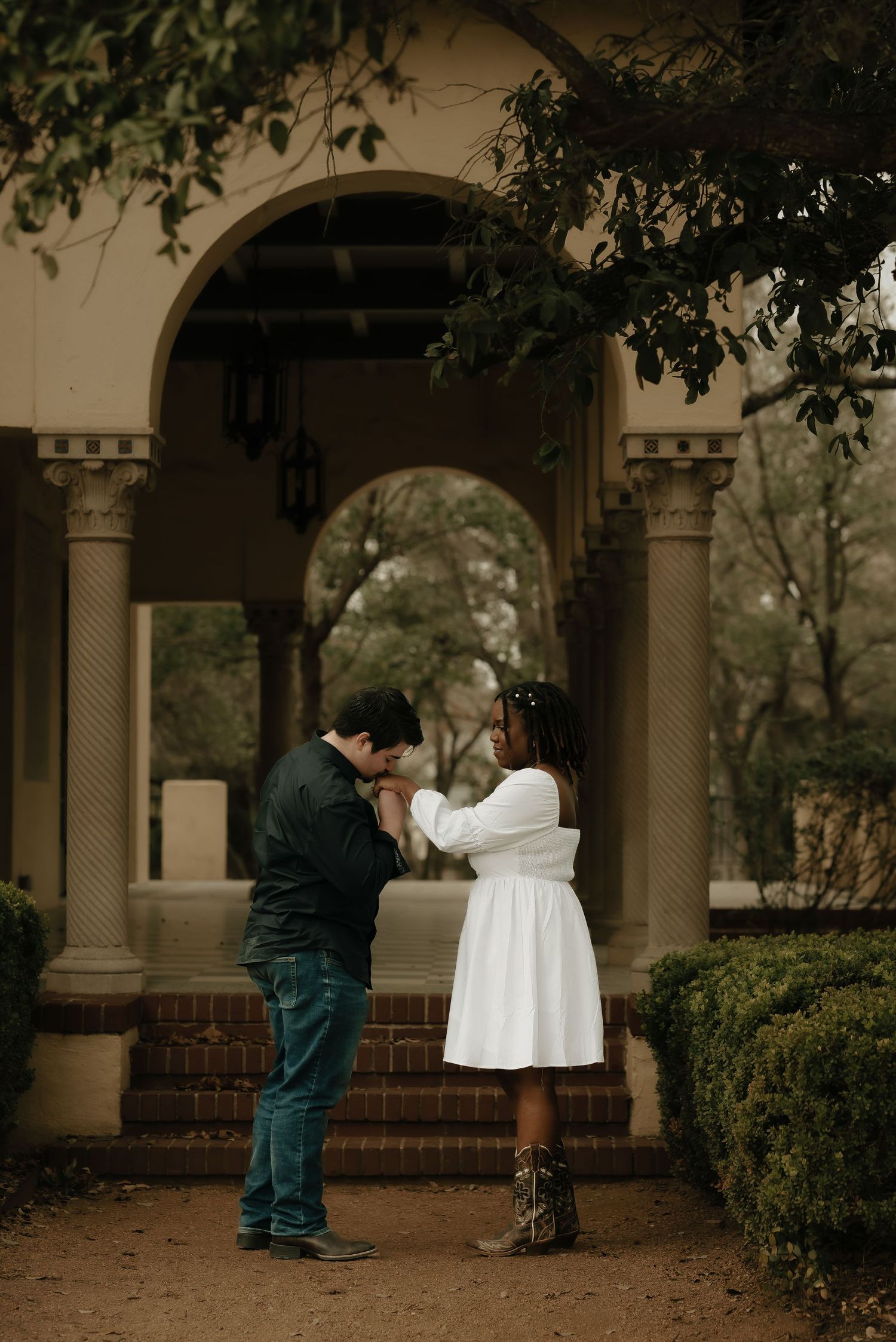 A romantic photoshoot sequence under architectural arches with soft natural lighting.