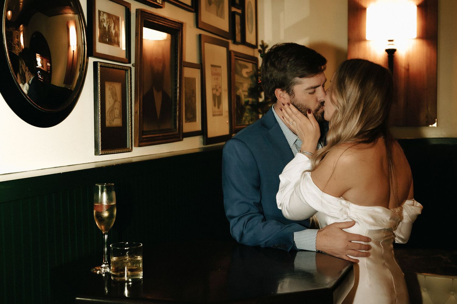Intimate moment shared in a dimly lit bar with vintage decor.