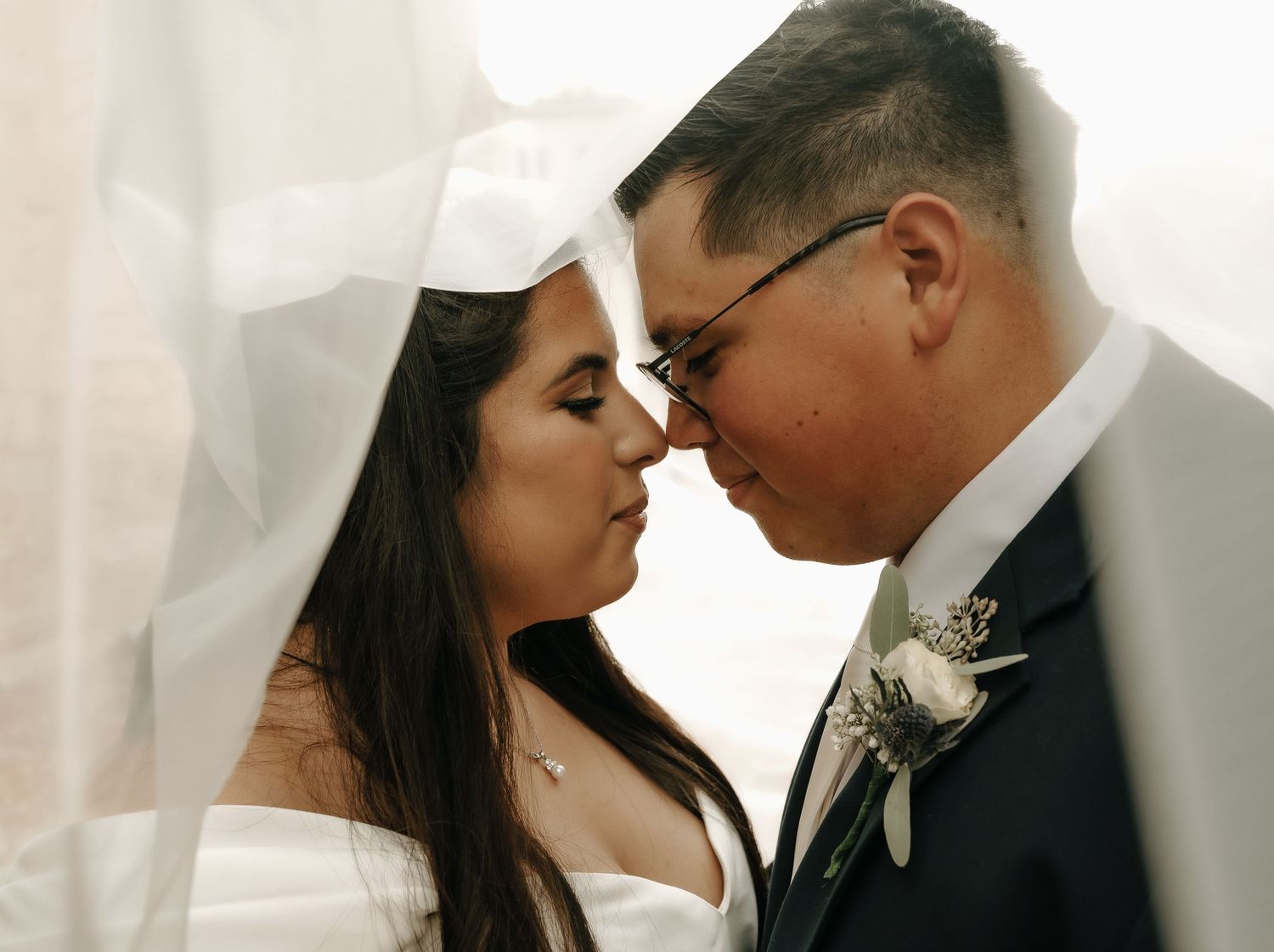 Intimate close-up wedding portrait with soft lighting and delicate details.