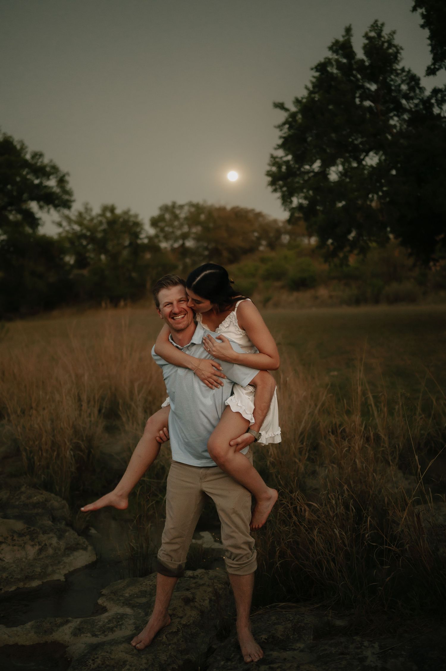 A playful moment captured in a field during golden hour.