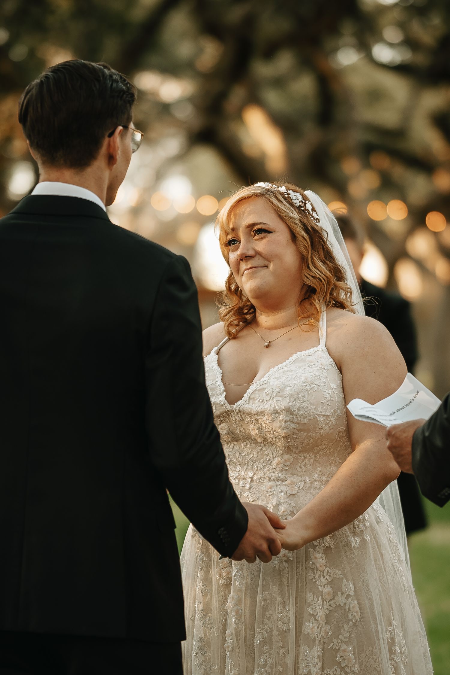 Joyful wedding ceremony moment captured in warm golden sunlight.