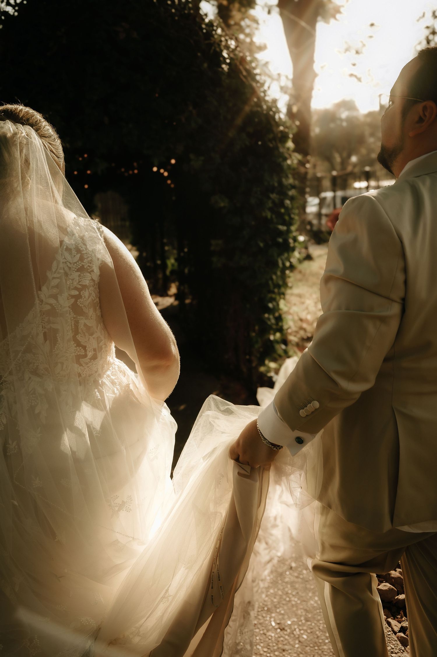 Romantic silhouettes of a wedding couple dancing together at sunset.