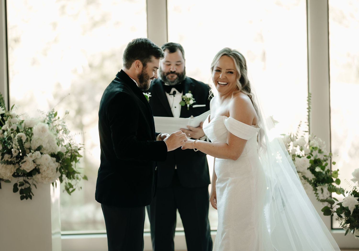 Wedding couple sharing an intimate moment during their first look in a bright modern venue.