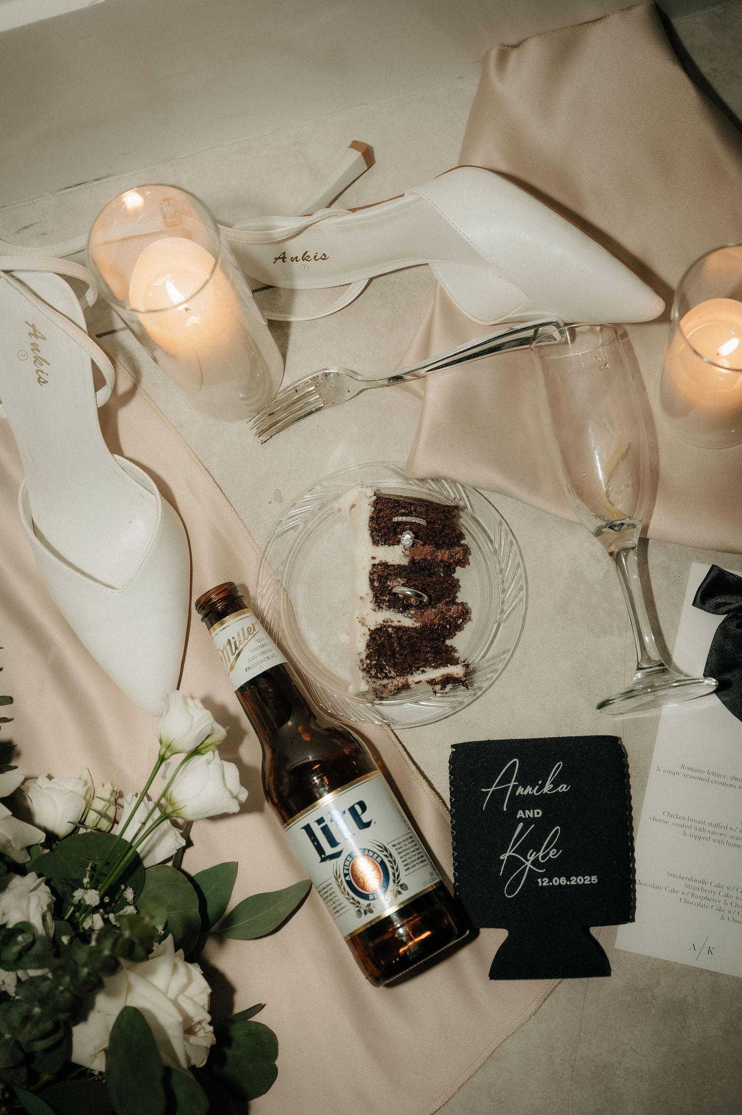 Wedding reception table setting with candlelight, place cards and chocolate desserts.
