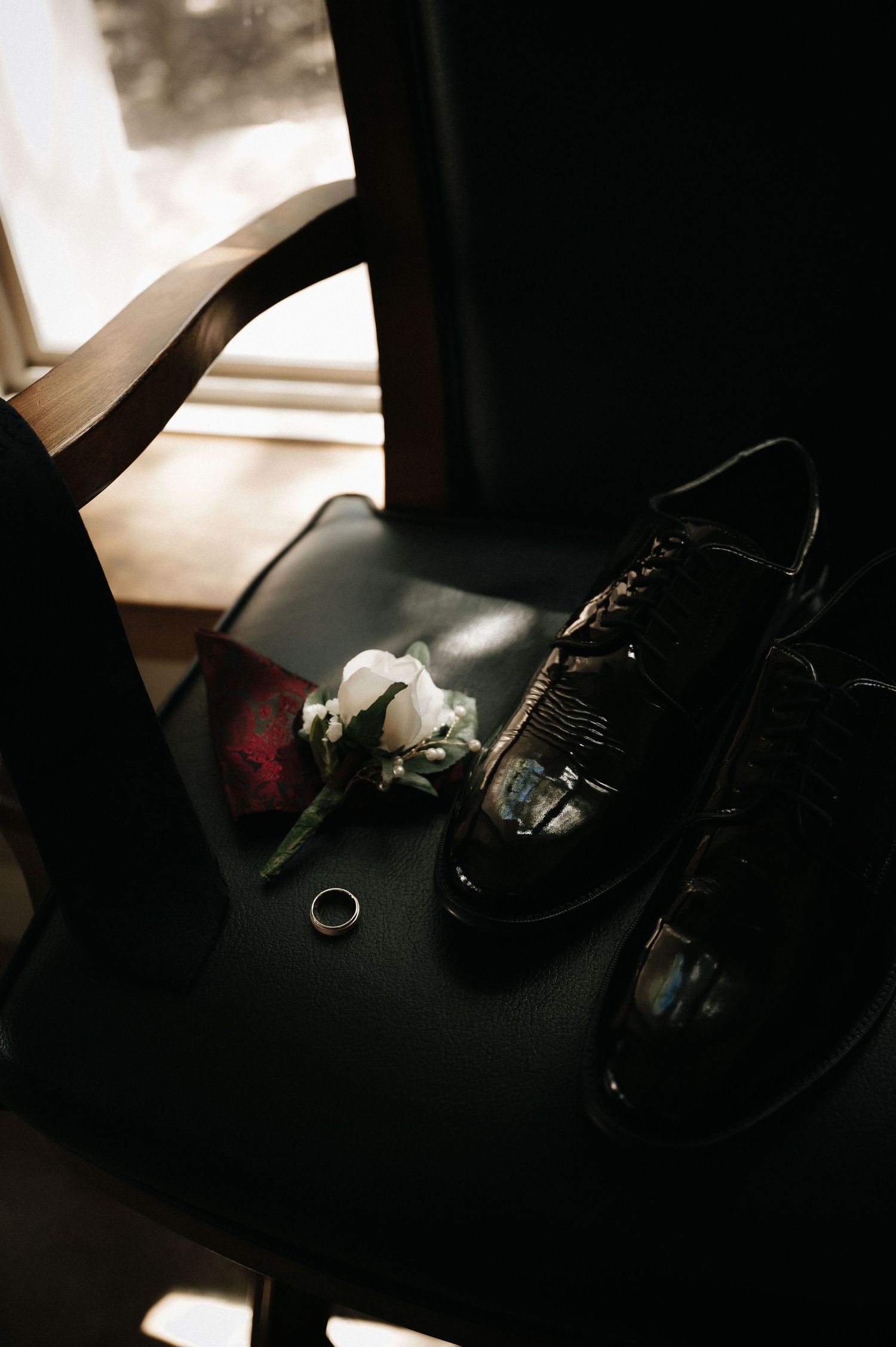 Wedding photography equipment and accessories arranged on a dark surface.