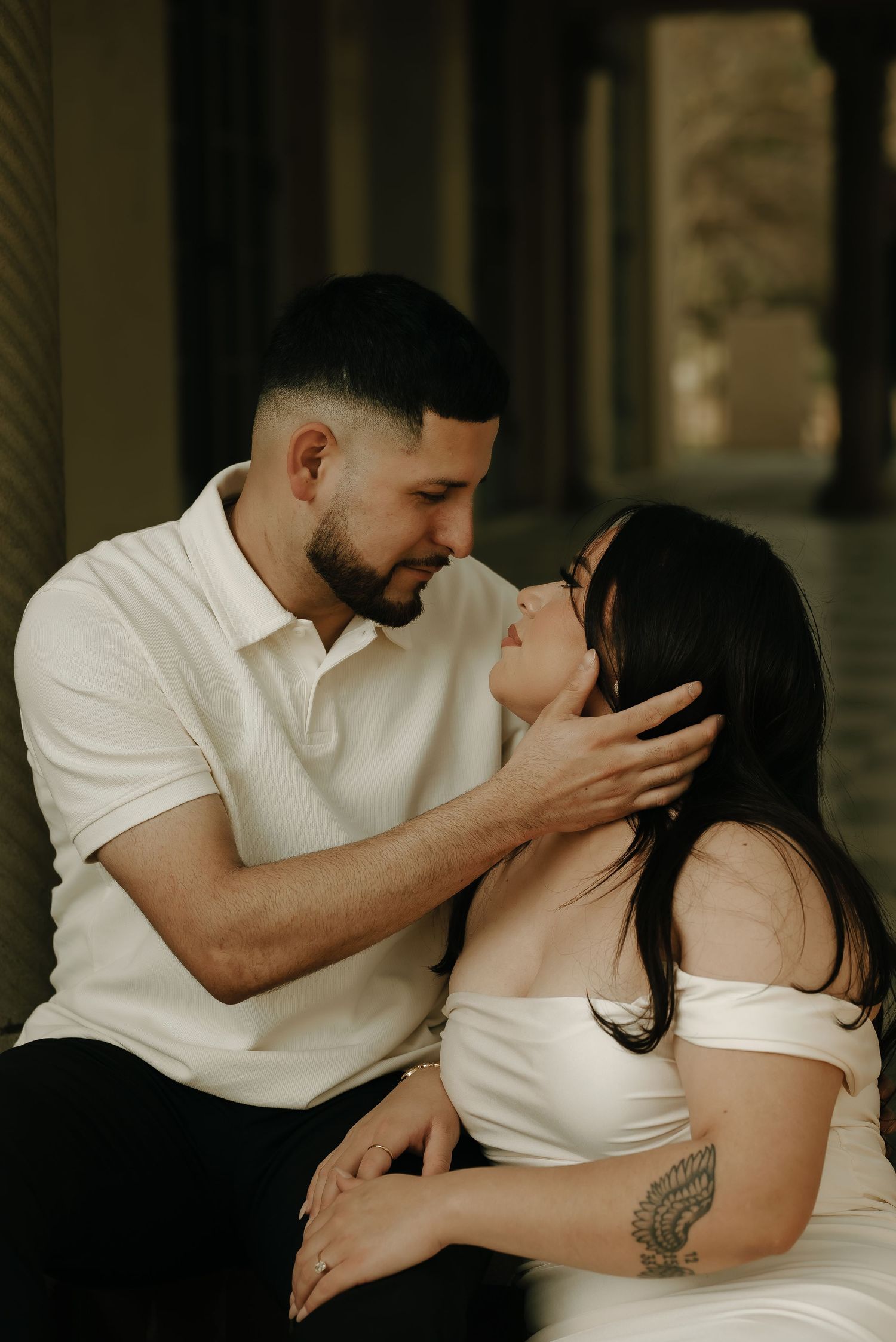 An intimate portrait series showing tender moments between a couple dressed in white.