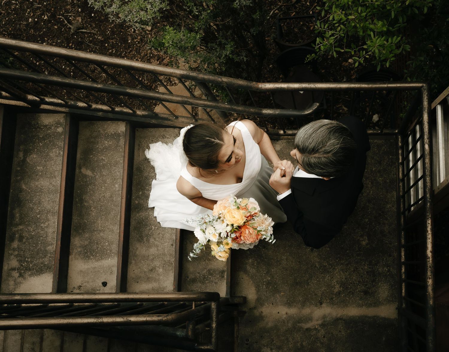 Couple dancing in a dimly lit industrial-style venue with exposed beams.