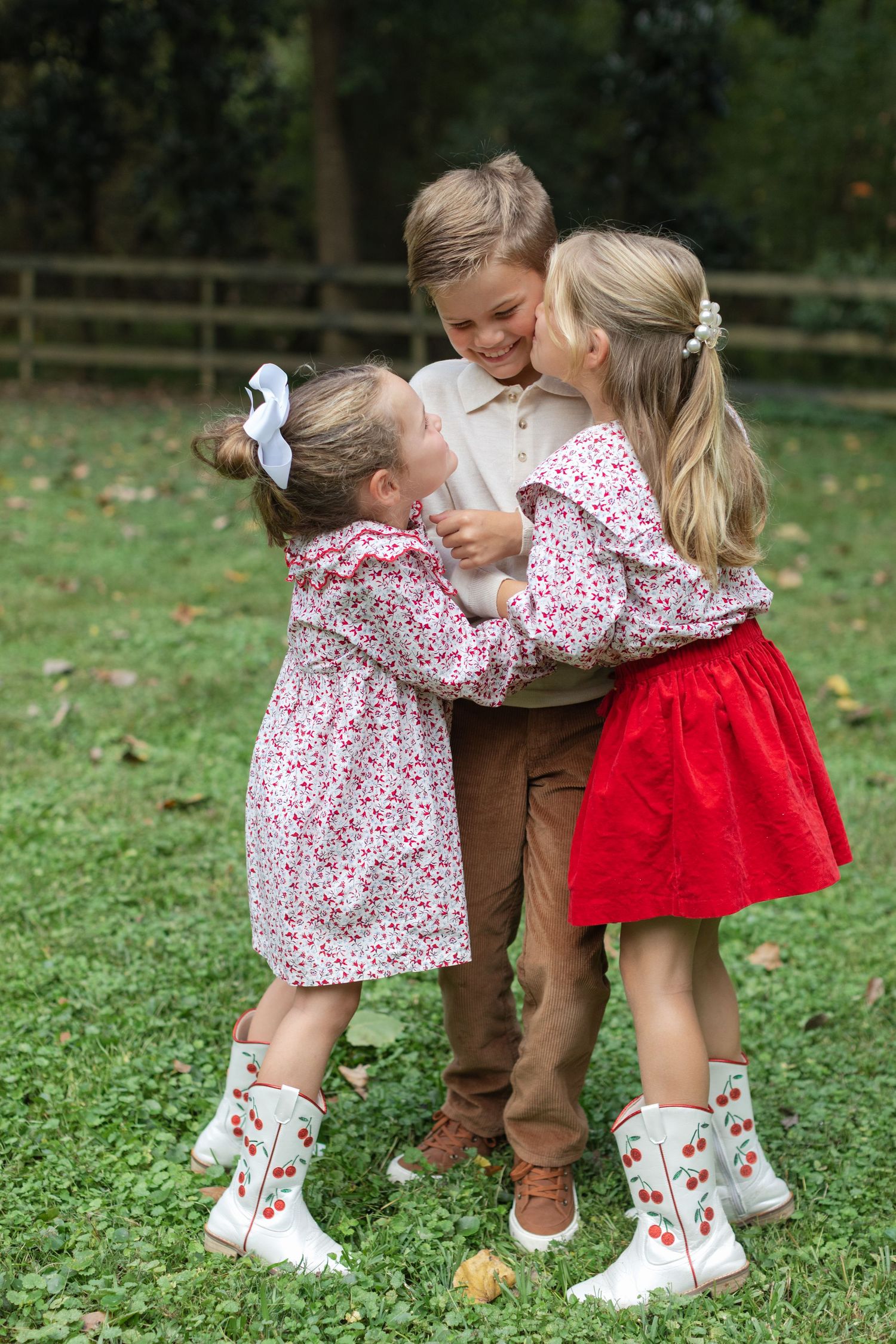 Three progressive photos show children playing and embracing in a grassy outdoor setting.