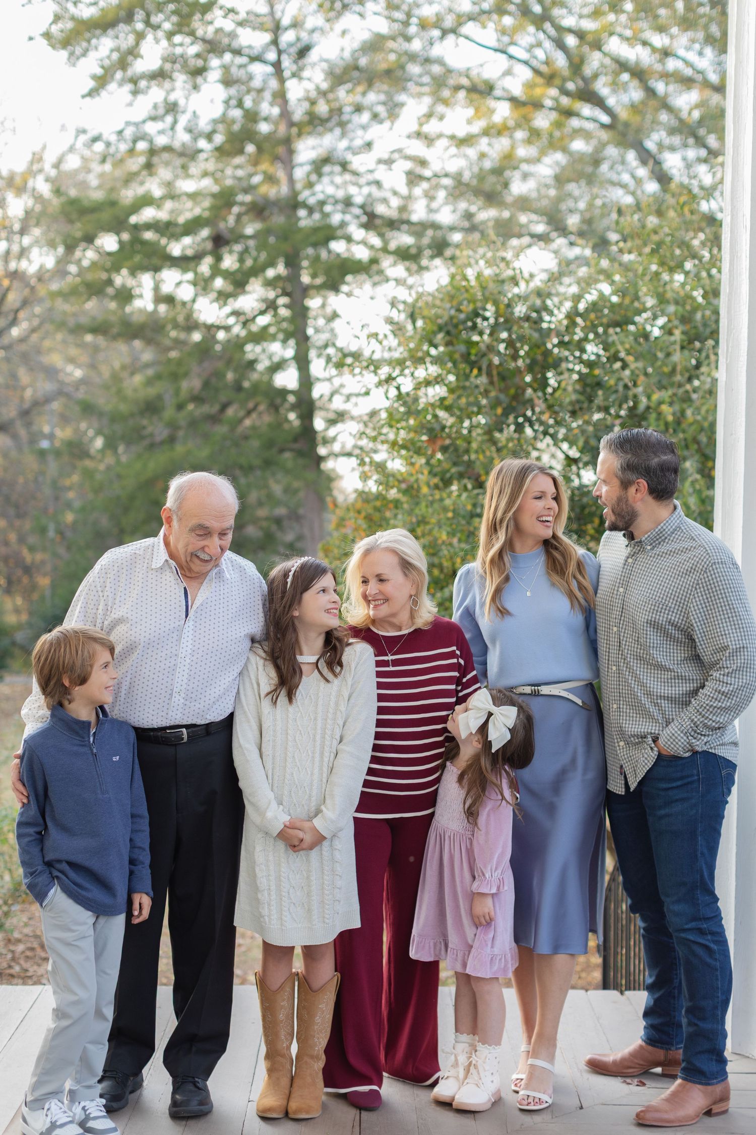 A multi-panel sequence showing a family group in casual attire standing together outdoors against a natural backdrop.