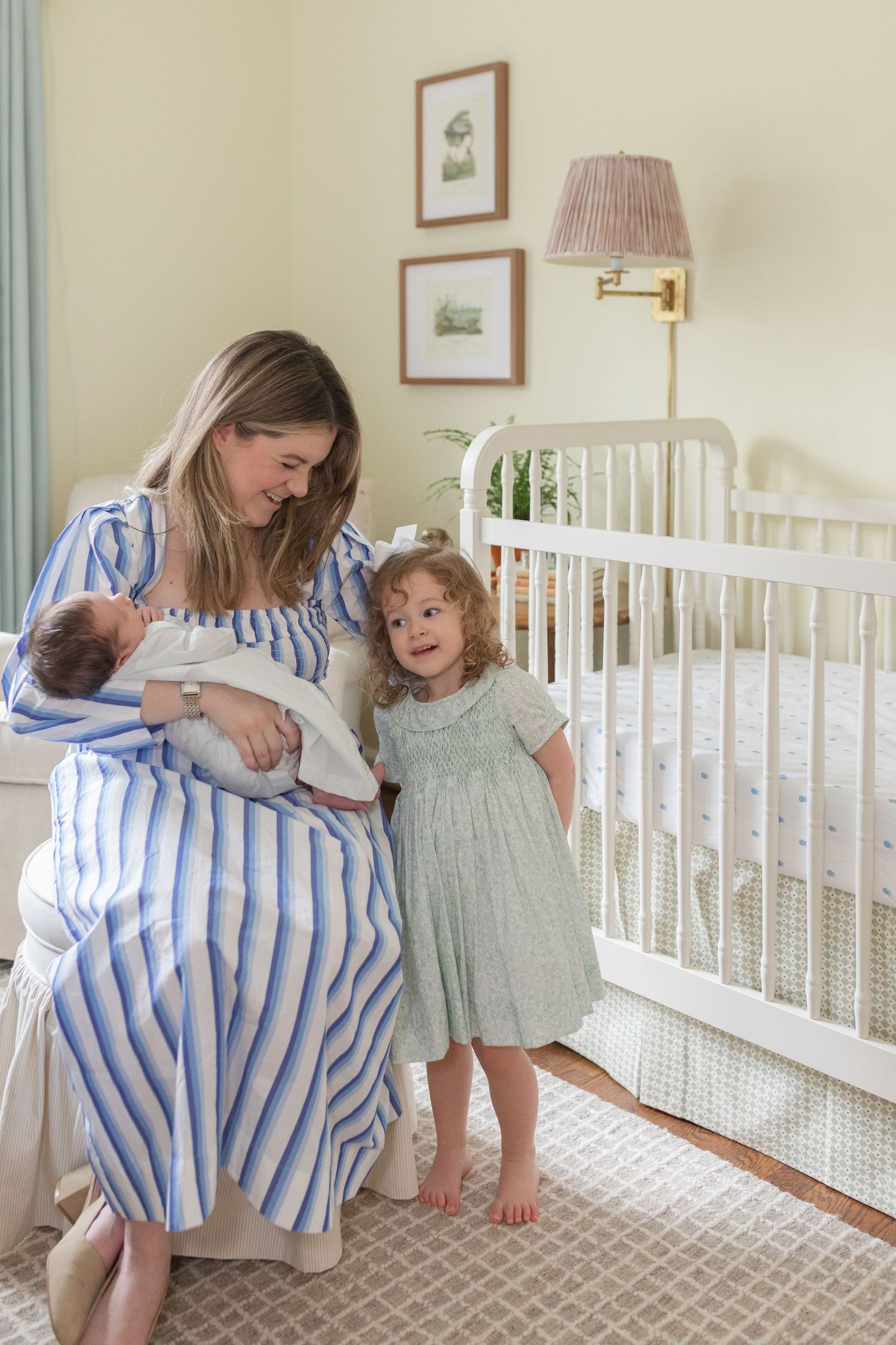 A series of photos showing tender family moments in a nursery with a baby in a blue striped blanket.