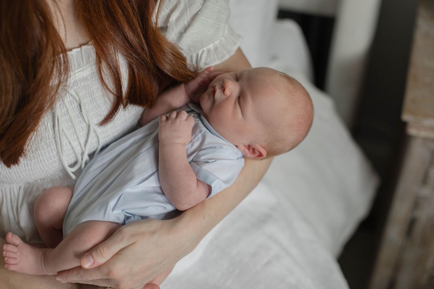 Tender moment between parents and baby during in-home lifestyle photo session.