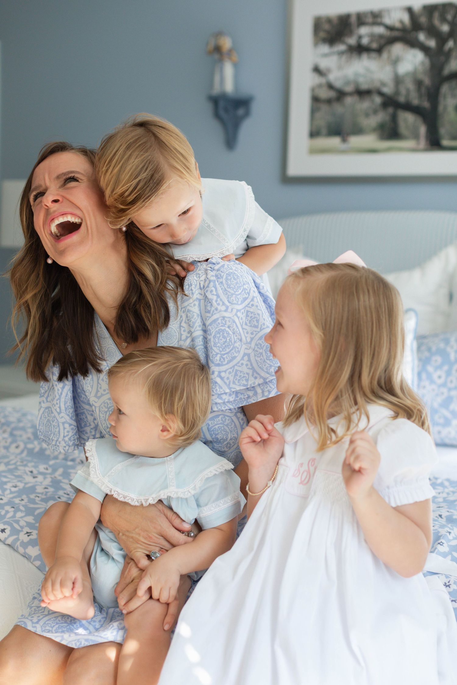 A heartwarming sequence of candid family moments showing joyful laughter on a bed with white linens and blue walls.