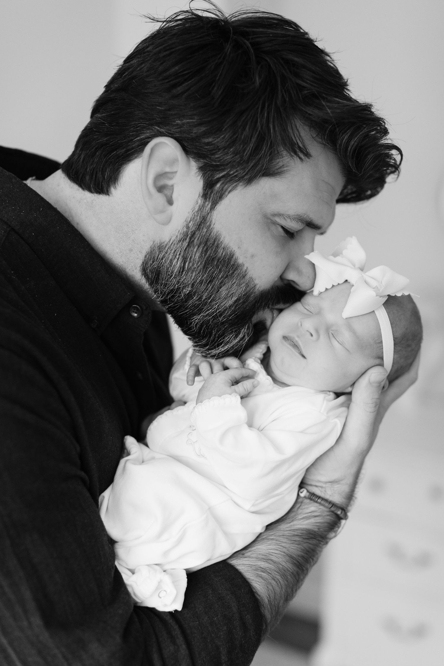 Black and white series of intimate moments showing gentle kisses and tender embraces.