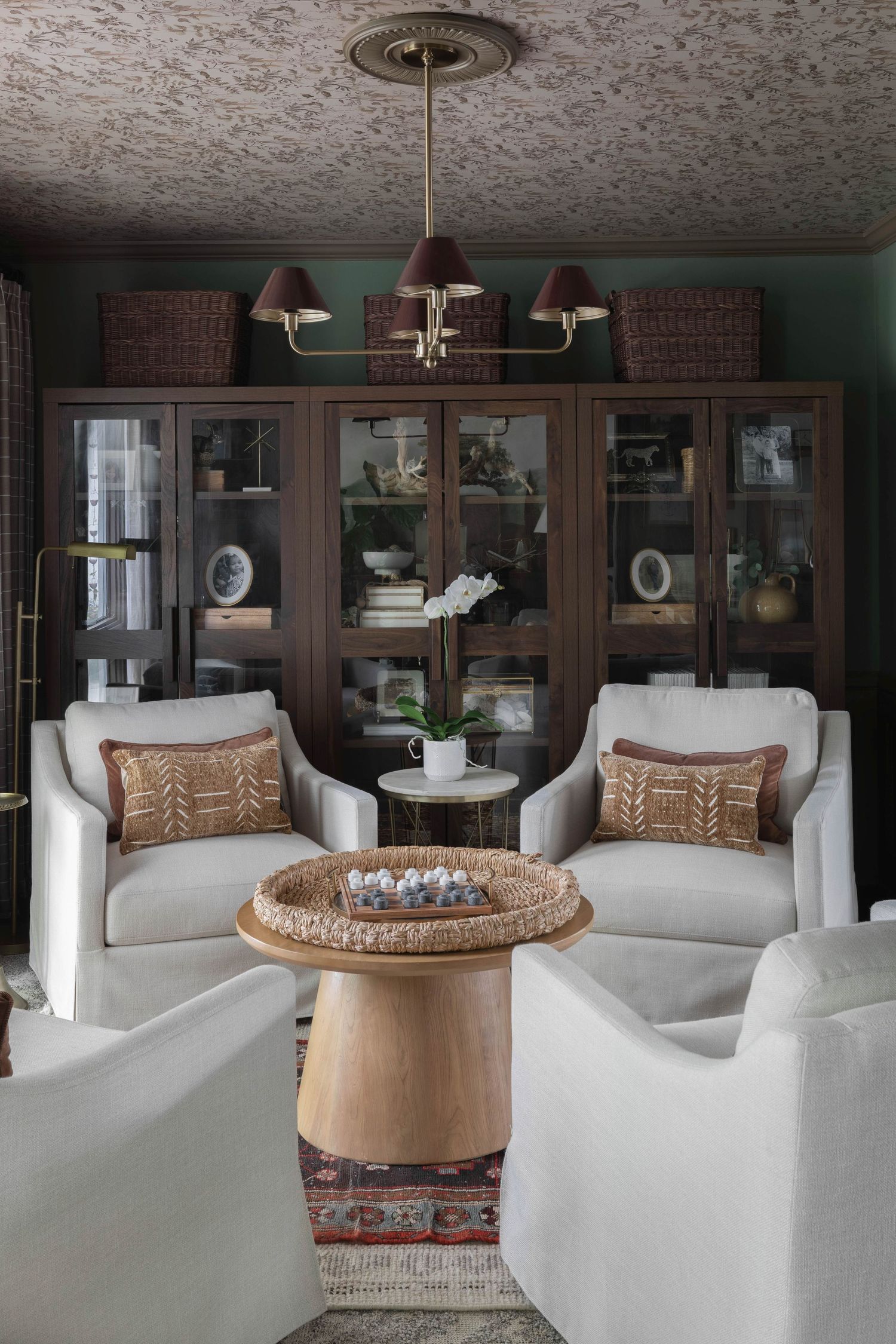 Elegant living room with white upholstered chairs and built-in dark wood shelving.  Atlanta Interior Design Photography
