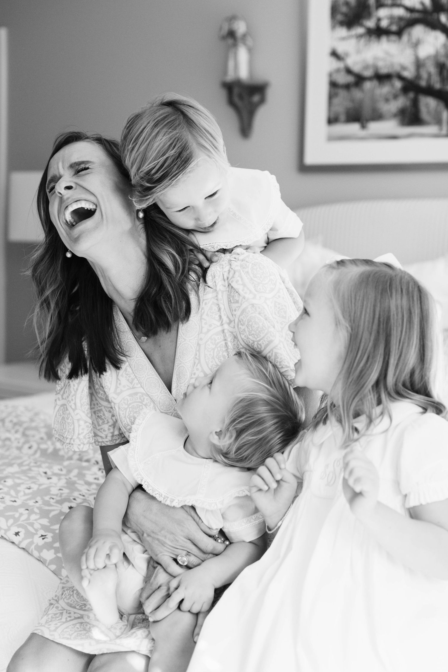 Black and white photo series showing intimate moments between mother and young child sharing affectionate hugs and laughter.