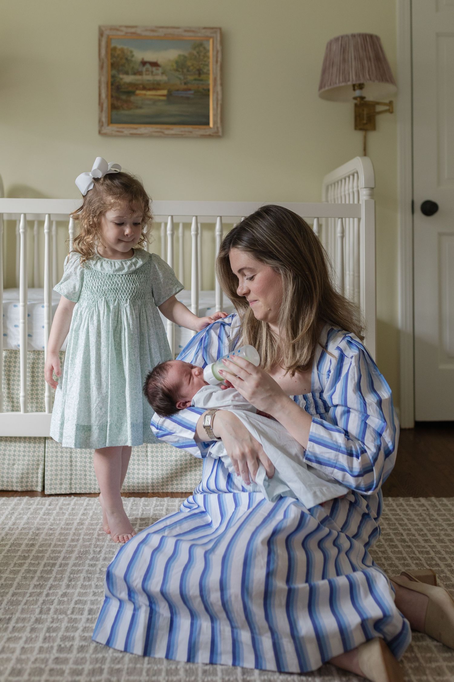 A sequence of tender family moments in a nursery room with white furniture and cream walls.
