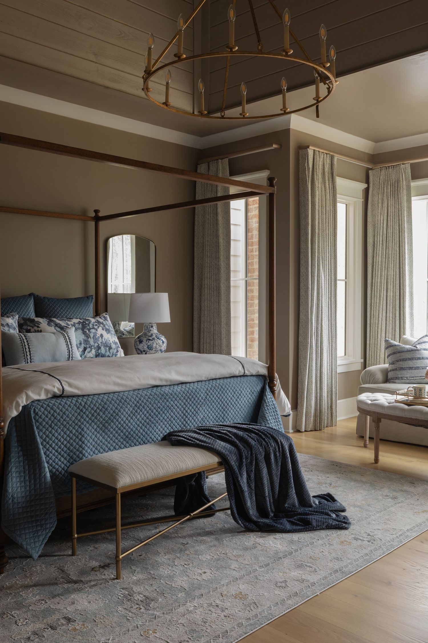 Elegant bedroom with canopy bed, blue bedding, and neutral decor showcases multiple angles of the same luxurious space.