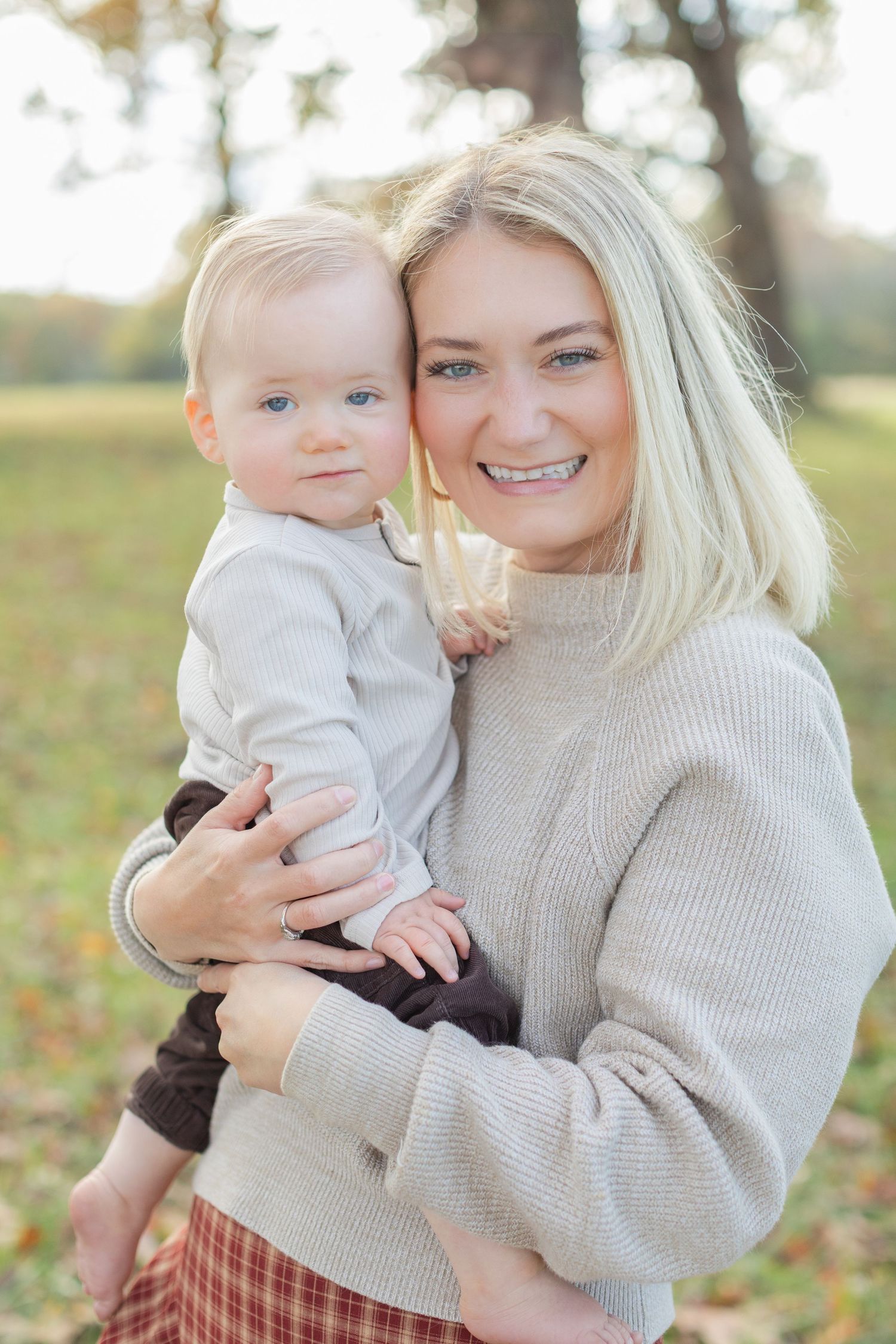 A heartwarming autumn photoshoot in a park with fallen leaves and cozy sweaters.