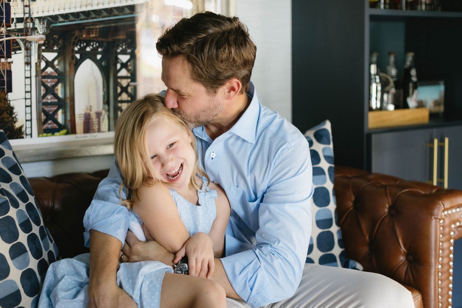 A tender moment between people in a modern kitchen interior shows affection and intimacy in a casual home setting.