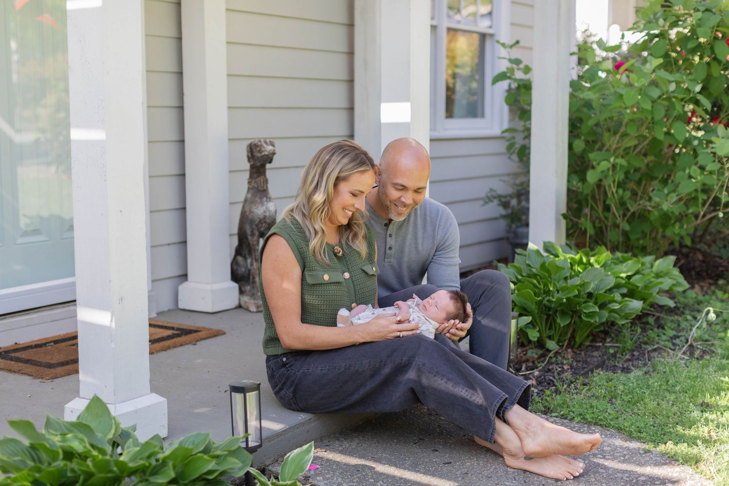 Relaxing family moment on a front porch with greenery.