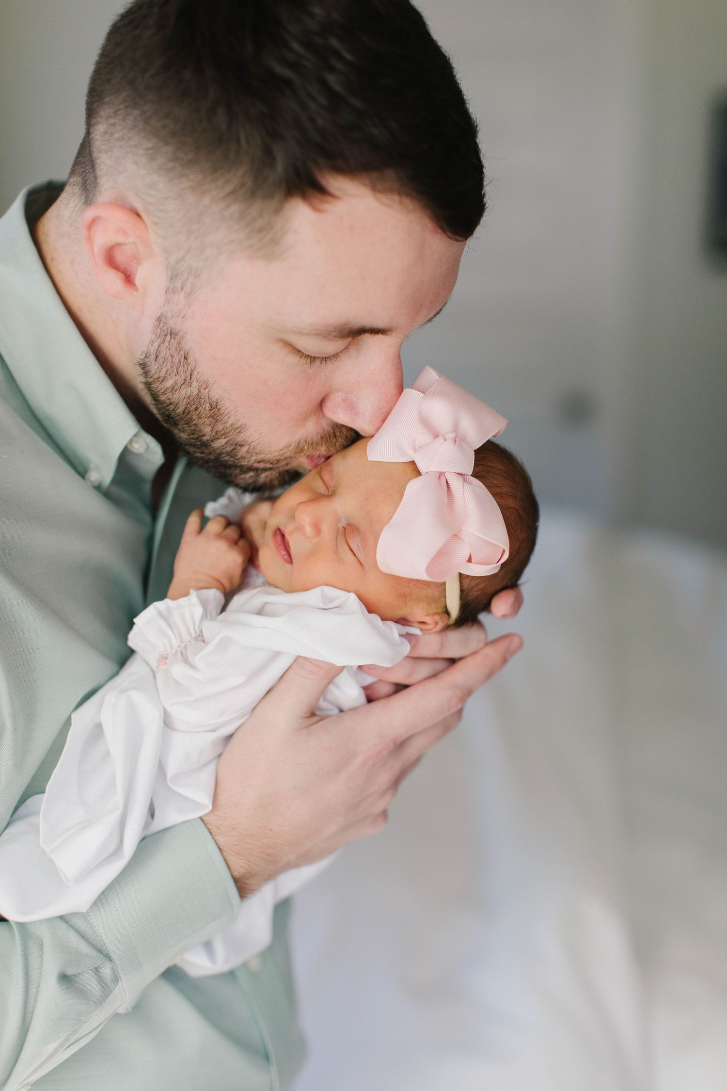 Intimate newborn photography session with soft white fabrics.