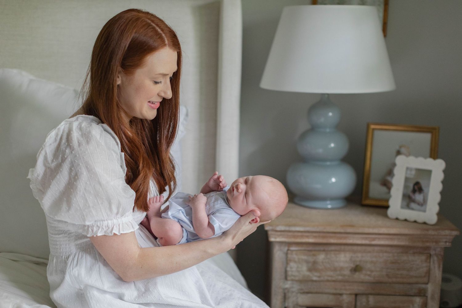 Lifestyle newborn photography session showing tender family moments in natural light.