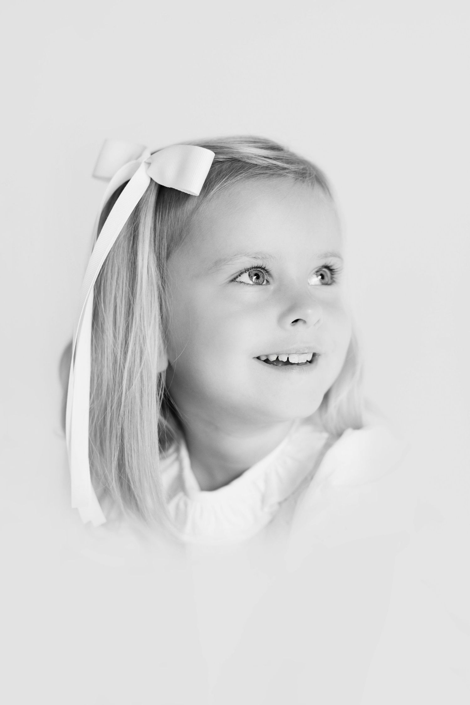 Close-up black and white portrait series showing expressions and profiles against a white background.