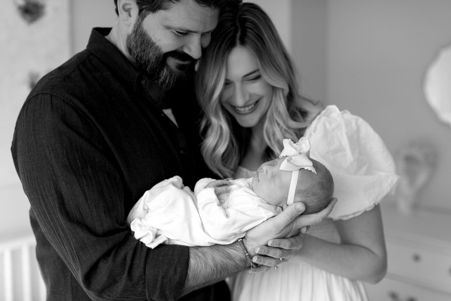 Monochrome series showing emotional moments between parents and their newborn baby.