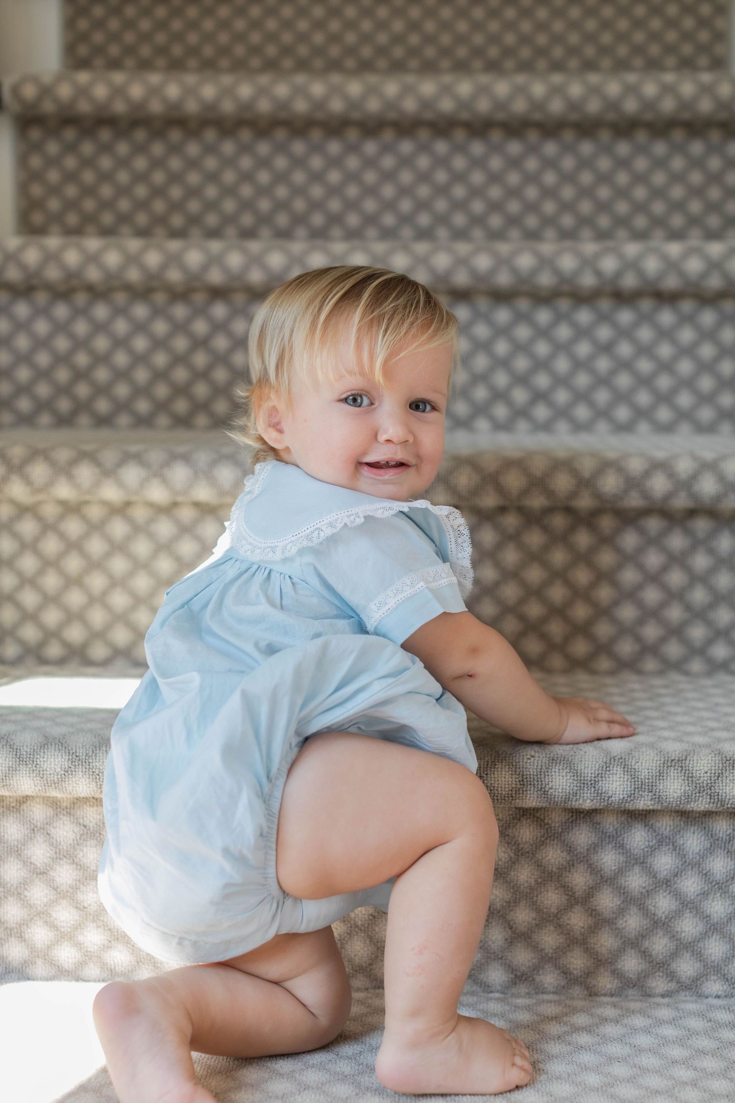 Baby in light blue outfit crawls across a patterned surface in interconnected photos showing movement sequence.